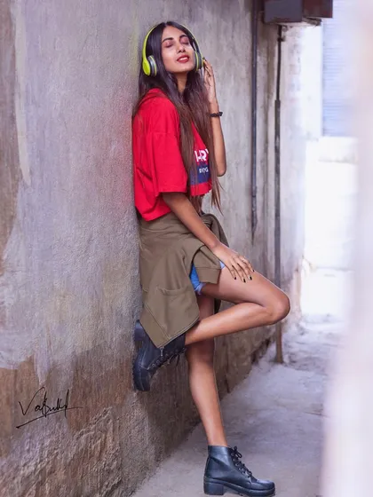 Feeling the music in a quiet city alley. This lifestyle shot is all about capturing a mood, using headphones as a prop to tell a story of personal escape and connection to music.