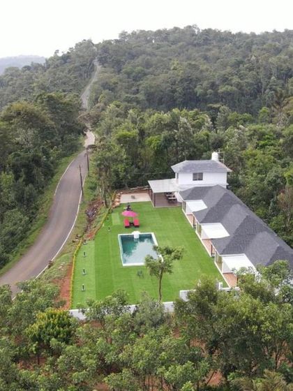 An aerial shot of the Panorama Peaks Cottage in North Coorg, a premium homestay set high up in a coffee plantation, offering complete seclusion and luxury.