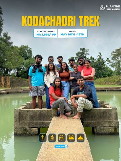 A group poses by a serene temple pond on the Kodachadri trek.