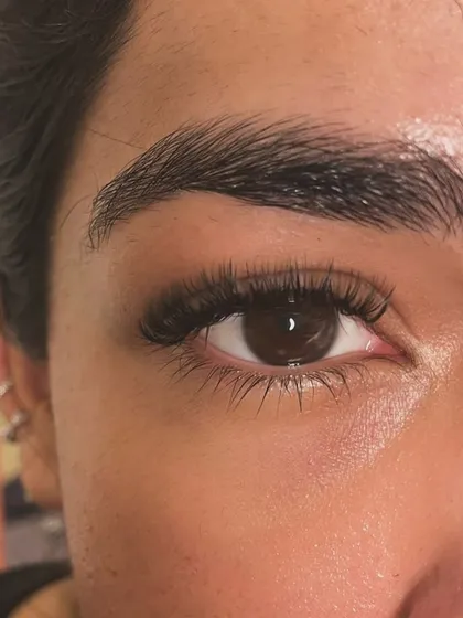 Another angle of the natural mascara inspired set. Notice how the extensions blend seamlessly with the client's own lashes for a flawless finish.