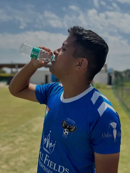 Beating the Delhi heat. A player stays hydrated during a sunny training session, a critical habit for any serious athlete.