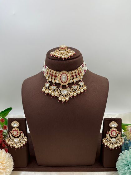 This collection showcases our premium Moissanite Kundan necklaces like the 'Noor Nazaakat' and 'Darbaar' sets. Each comes with a full set of earrings and maang tikka, available in various color combinations.