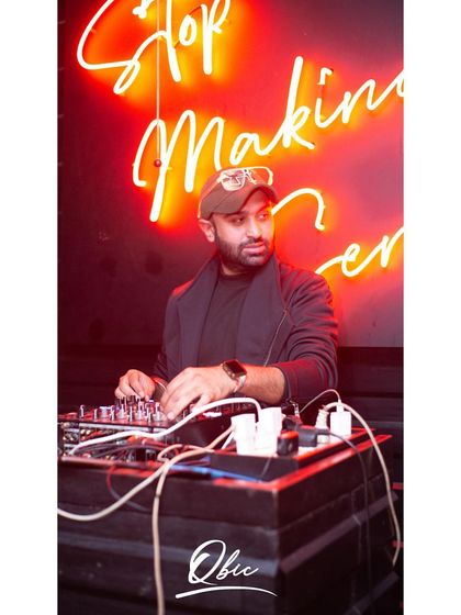 In the zone at Qbic, with the club's signature neon sign in the background. Each venue has its own unique character, and I adapt my style to fit the space.