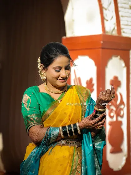 A candid shot of the bride adjusting her bangles. The sunlight catches the glow of her makeup, creating a beautiful, ethereal effect.