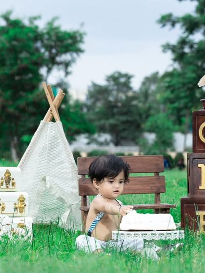 This little one is getting ready to smash his cake at his first birthday picnic.