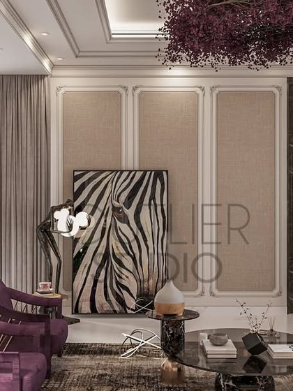 This neoclassical living area tells a story of timeless elegance. It features a stunning bookmatch marble backdrop, classic mouldings, and modern neutral furniture with a bold pop of purple for a touch of drama.