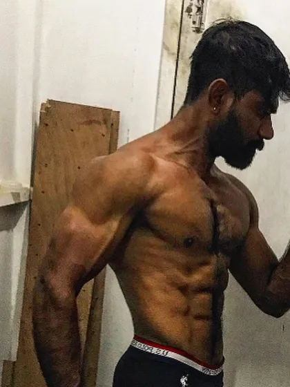 A classic physique pose, showing the results of consistent training.