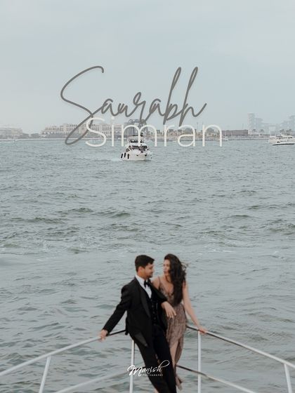 A beautifully styled portrait on the bow of the yacht, with their names elegantly scripted, perfect for a 'save the date'.