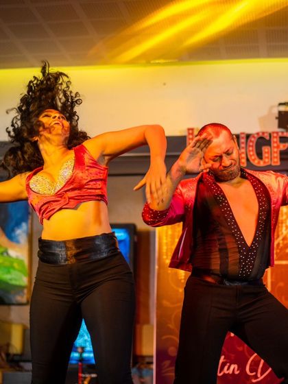 The pure high of being on stage. This action shot captures the peak of a dynamic move, showing the raw energy and physical commitment that goes into every single performance.