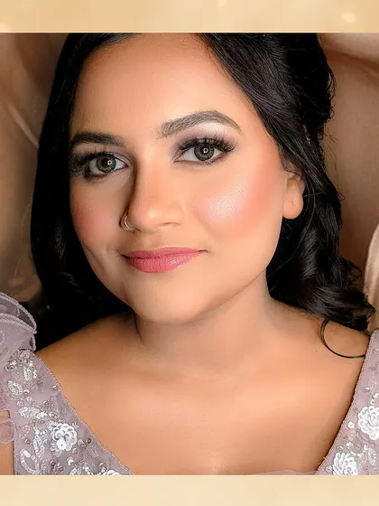 A beautiful close-up portrait. The soft smokey eye and perfectly blended skin create a look of sophisticated glamour.