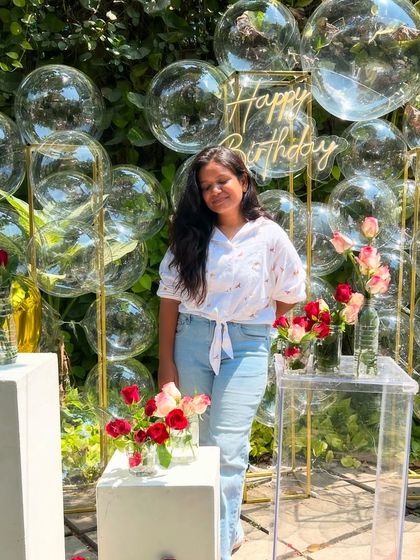 Our founder Gauri posing with the unique bubble backdrop, a modern and playful option for any birthday or event.
