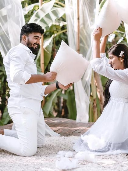 Another angle of the playful pillow fight, this shot captures the action and fun from a different perspective.