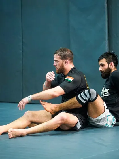 Two high-level grapplers work on leg entanglement positions. Seminars like these allow experienced practitioners to refine their game and learn the latest developments in the sport from specialists.