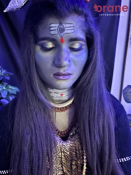 A divine fantasy makeup look inspired by Lord Shiva for Mahashivratri, featuring the iconic third eye and serene expression.