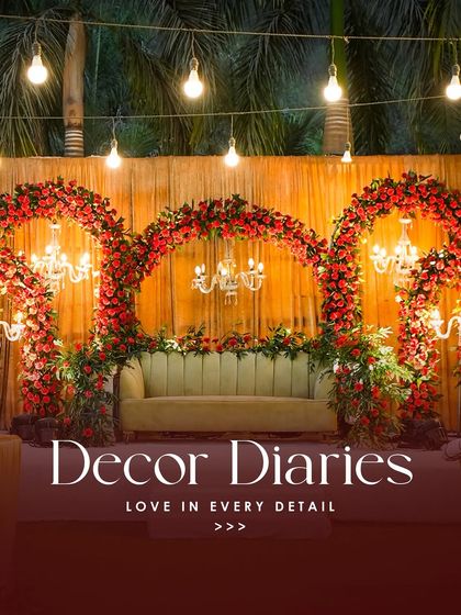 This reception stage combines traditional red floral arches with classic chandeliers, creating a look of timeless elegance. It’s a perfect example of how we blend different decor elements to create a cohesive and beautiful design.