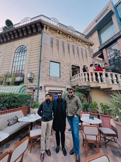 With friends outside a classic European-style building. As the saying goes, a lawyer's time and advice are his most valuable assets.