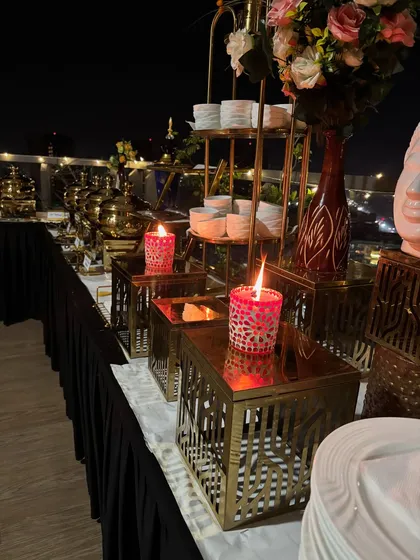 Candlelight adds a warm and intimate touch to this rooftop buffet, enhancing the overall dining experience.