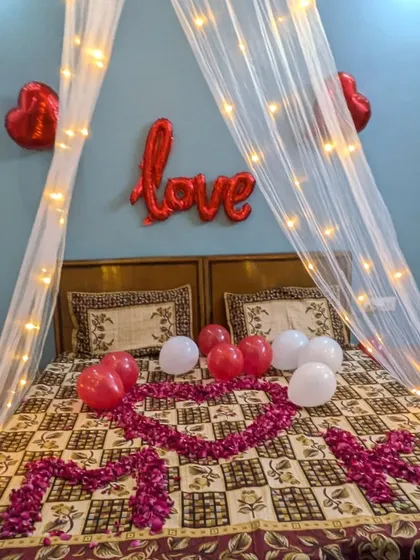 A detailed look at the bed decoration, showing the 'MOM' spelled out in rose petals for a special occasion like Mother's Day or a birthday.