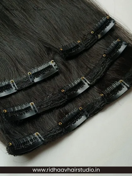 A close-up of the secure clips and fine wefts of our 4-piece straight clip-in set, designed for comfort and a discreet look.