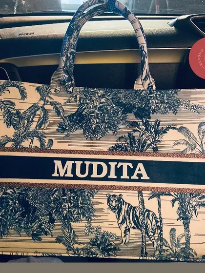 Our personalised suede tote bag in a classic blue and white tiger print, sitting in a car, ready for a road trip.