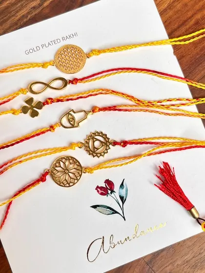 Bless him with Abundance. These delicate and elegant gold-plated rakhis are available in many designs, like the Sri Yantra and Hamsa symbols.