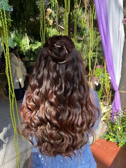 The back view shows the beautiful texture of the curls and the unique placement of the diamond string for a touch of sparkle.