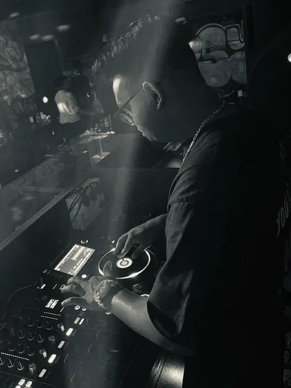 A black and white shot capturing my focus while DJing. My performance is about precision and a deep love for the music, whether it's hip-hop, pop, or R&B.