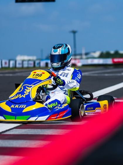 A clean shot of our driver on the racing line, framed by the red and white kerbing of the track.