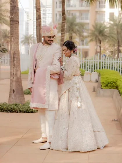 A candid moment during a couple's portrait session. The soft pastel outfits and the gentle interaction make for a sweet, romantic photograph that feels natural and effortless.