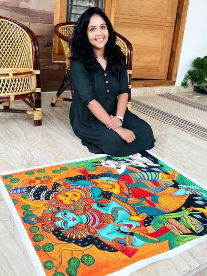 Me with the finished Radha Krishna painting, a piece I truly loved creating. The colors are so vibrant and full of life.
