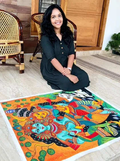 Me with the finished Radha Krishna painting, a piece I truly loved creating. The colors are so vibrant and full of life.