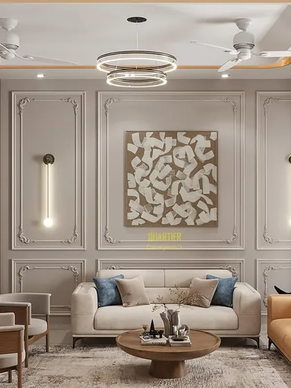 For this living area, I created a feature wall with classic European-style molding and modern sconce lighting. The neutral color palette allows the furniture and art to stand out, resulting in a space that feels both timeless and contemporary.