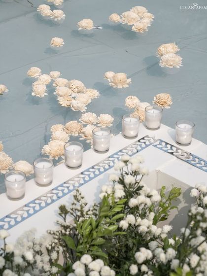 Floating flowers and candles in the reflecting pool, with its custom-tiled border, adding a layer of tranquility and beauty to the venue.