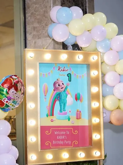 The welcome area for Kabir's party, with a lit-up sign and a JJ cutout to greet the guests.