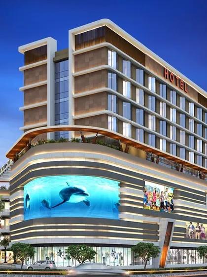 Another view of our landmark mixed-use hotel and commercial project. The design features a dynamic facade with curved elements and prominent retail frontage, making it a focal point in the urban landscape.
