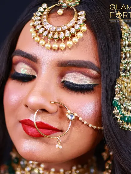 A detailed close-up of the Valima eye makeup. Notice the cut-crease with gold glitter, sharp winged liner, and a bold red lip, creating a high-impact, celebratory look.