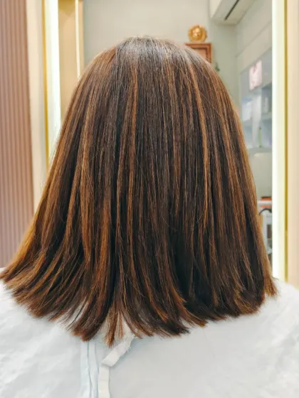 A classic straight bob with perfectly blended highlights. This is a timeless look that's both professional and stylish.