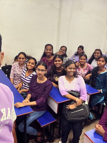 Students and their mentor celebrating the power and passion of purple on Day 9 of Navratri 2024.