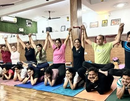 A human train of yogis. We build connections through fun, trust-building partner exercises.