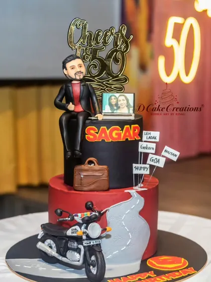 The biker cake in its party setting, with a "50" neon sign in the background. It's all about creating a personal story with every cake.