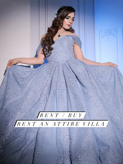 A professional shot of a model in my powder blue ball gown. The off-shoulder design and full, embroidered skirt create a timeless and elegant look, available for rent for your special occasion.