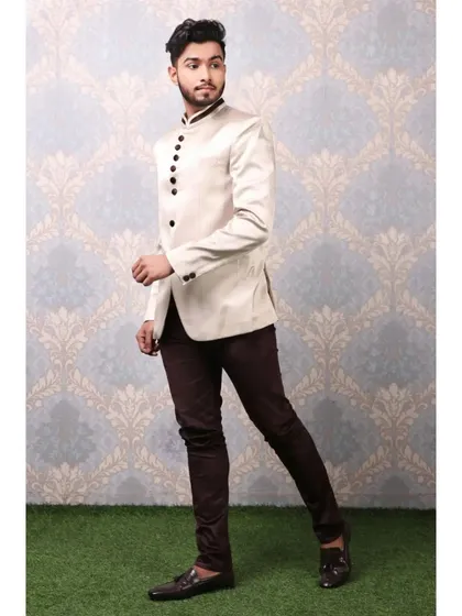 A male model in a stylish off-white Jodhpuri jacket, shot for a men's ethnic or formal wear brand.