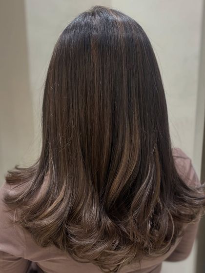 A closer look at a seamless balayage transformation. The warm tones are blended perfectly for a natural, glowing finish that enhances her base color.