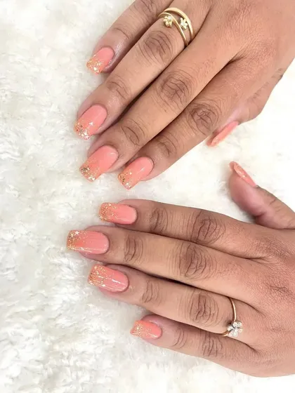 A full view of these subtle and glamorous bridal nails. The pastel peach and gold glitter combination is perfect for any wedding event.