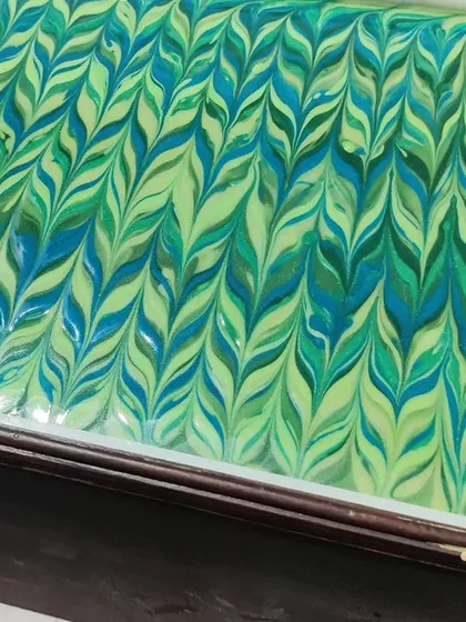 A slab of cooling Peppermint soap, made with fresh peppermint leaf juice. The green and blue feather swirl on top looks just as refreshing as the soap feels.