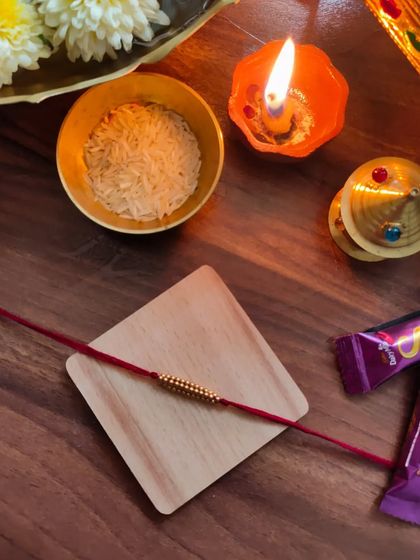 My most affordable rakhi design, priced at 20 rupees. This simple yet beautiful rakhi is made with golden beads on a red thread.