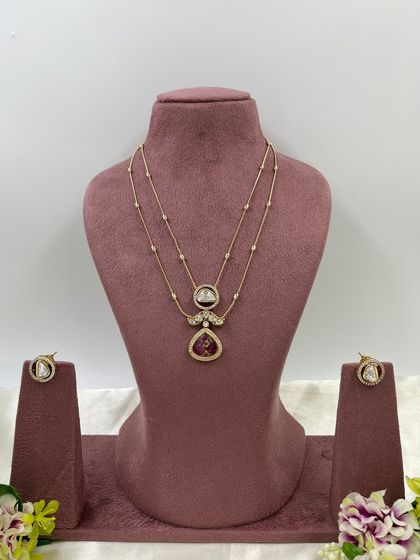 The Myra Crystal Bloom Necklace. This is another lightweight, double-chain design with crystal pendants, perfect for modern and minimalist tastes. Available in red and green.