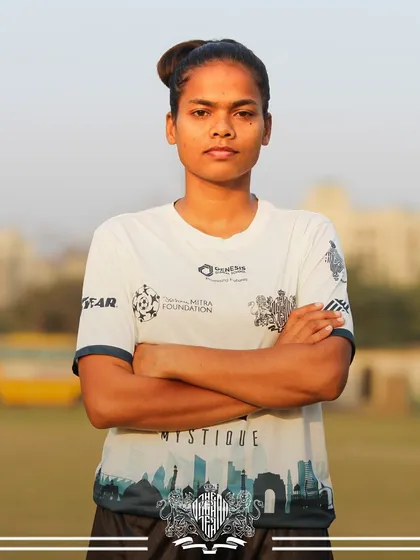 Steadfast and strong. A player stands with arms crossed, a pillar of strength for the team.