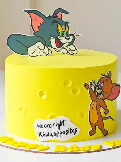 A playful Tom and Jerry cake designed to look like a block of cheese. This bright yellow cake captures the fun and rivalry of the classic cartoon duo, making it a nostalgic choice for all ages.