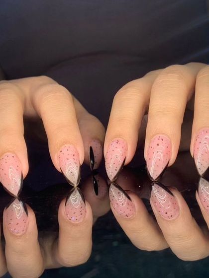 An edgy and unique design with a speckled pink base and sharp, black-painted tips.